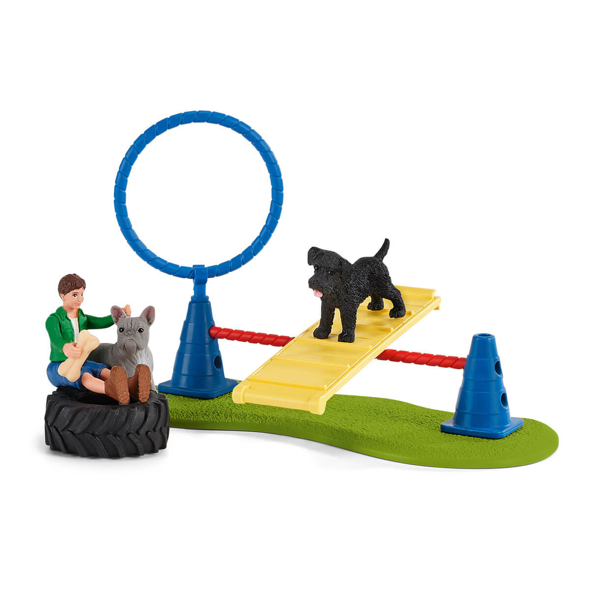 Spielzeug-Hundepark mit Hindernissen, einem Hundetrainer und zwei Hunden.