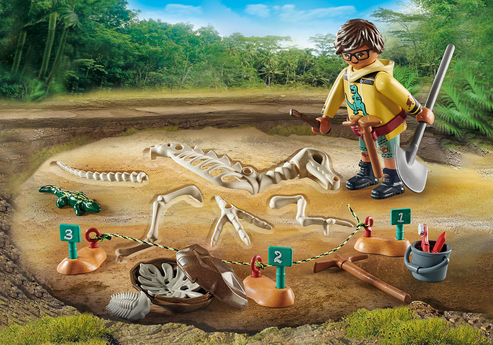 Eine Playmobil-Szene mit einem Jungen, der nach Dinosaurierknochen gräbt.