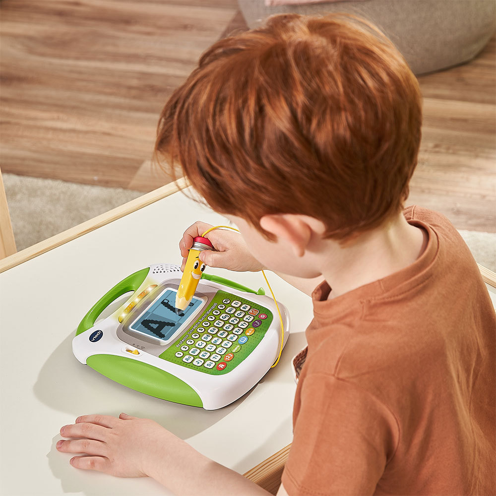 Ein Kind mit roten Haaren benutzt ein Spielzeugtablet und zeichnet mit einem gelben Stift.