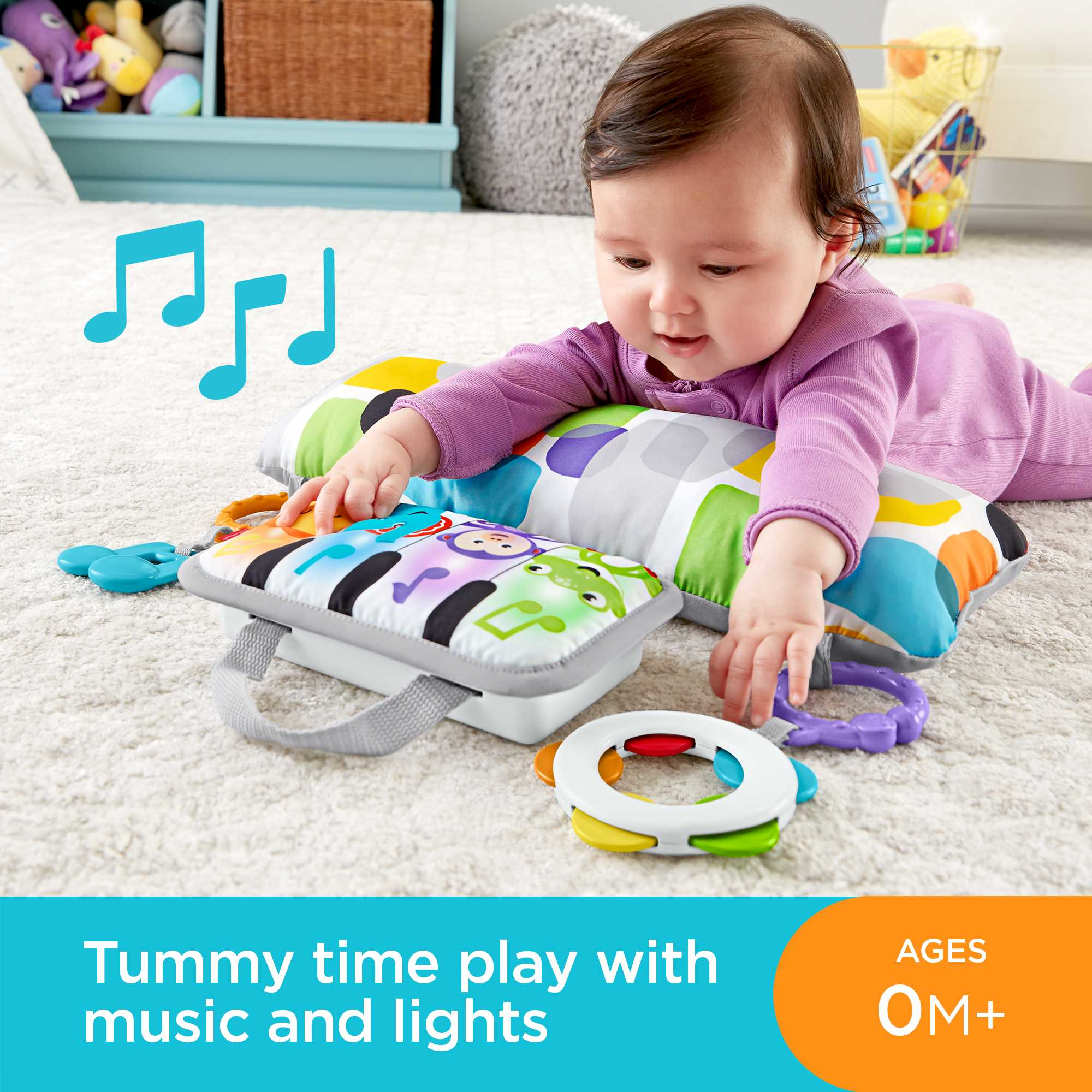 Baby spielt auf einer bunten Matte mit Spielzeug, Noten und Text.