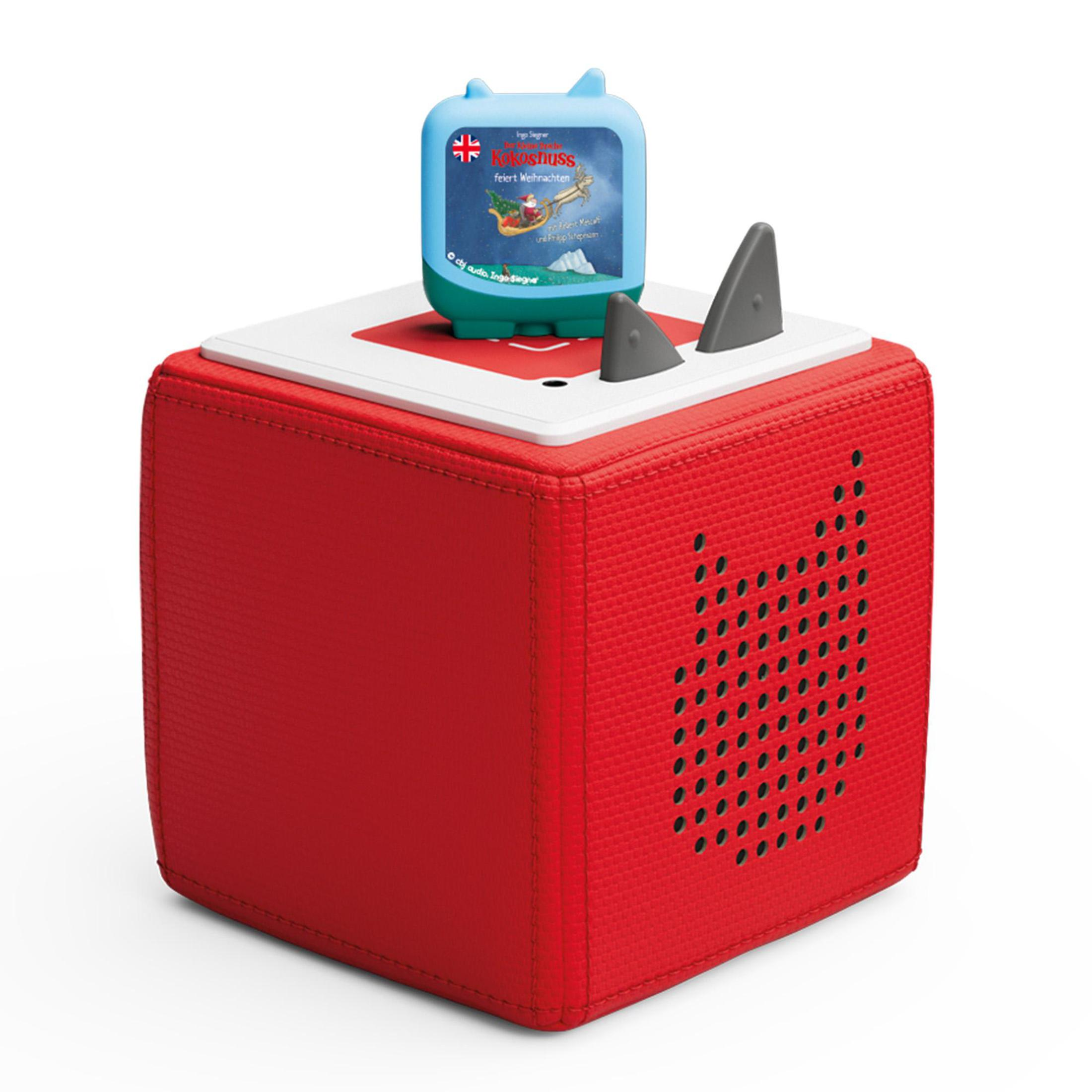 Ein roter Würfel mit blauem Deckel und zwei Zubehörteilen in Haifischflossenform mit Spielzeug.