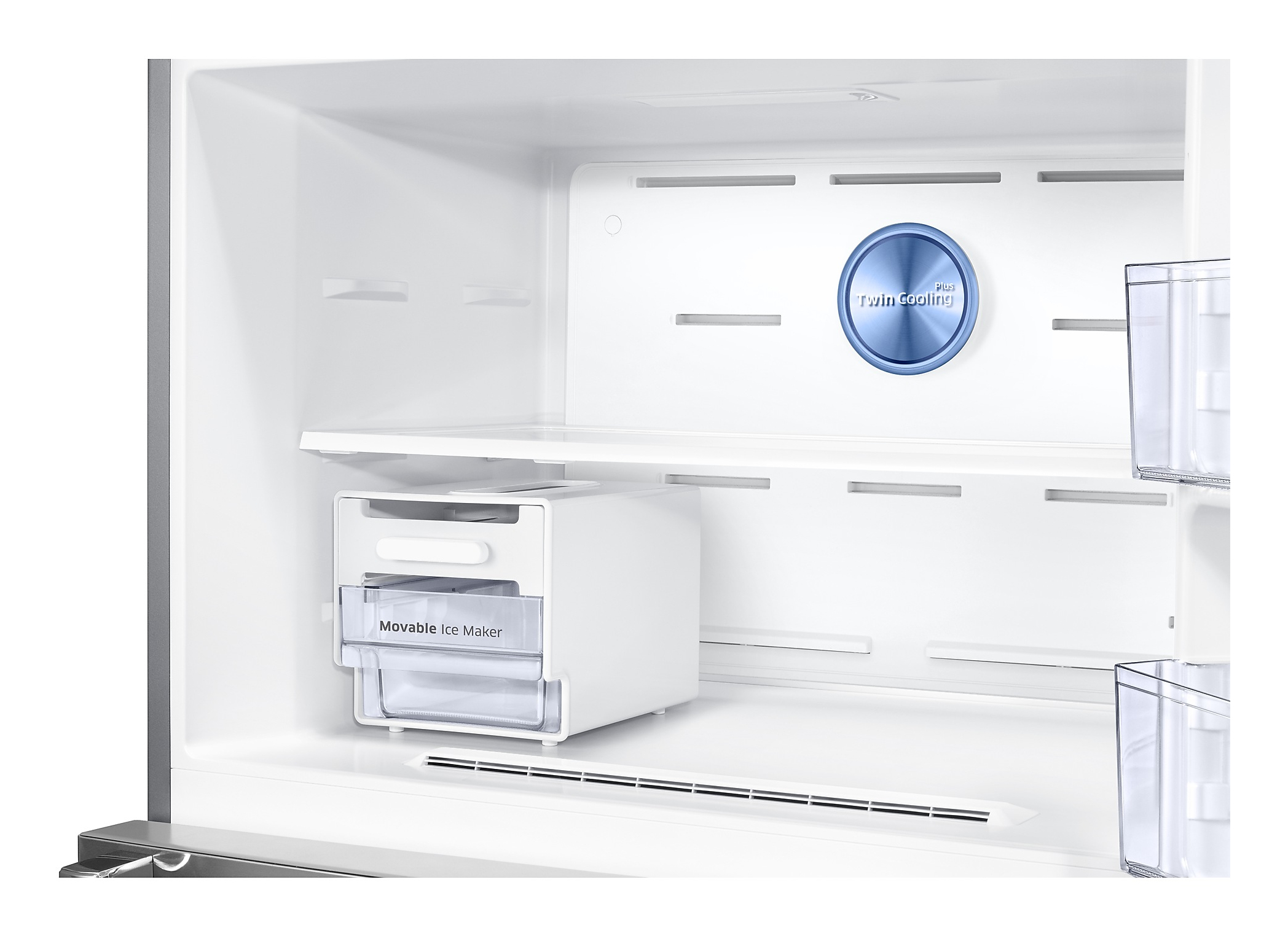Inside a white refrigerator. Shows shelves, ice maker, and ventilation. Blue Twin Cooling logo on the back.
