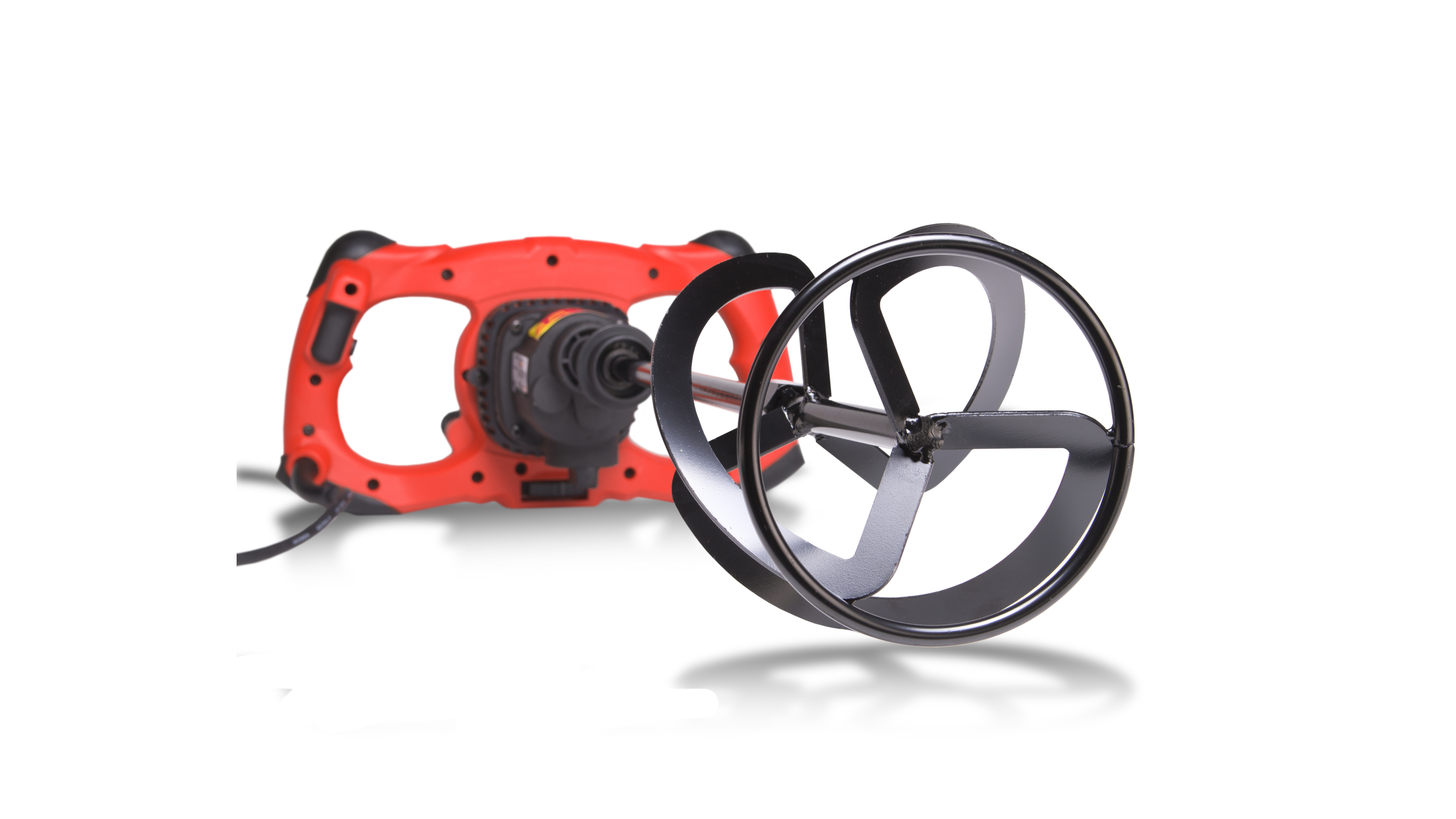Miscelatore elettrico rosso con un accessorio di miscelazione nero. L'accessorio è vicino alla fotocamera.