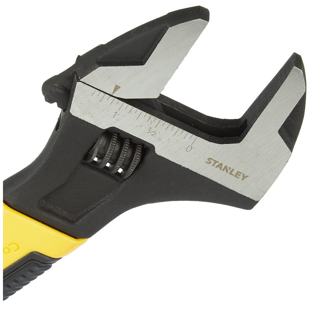 Close-up of a black and yellow Stanley wrench. The open jaws show measurement markings.