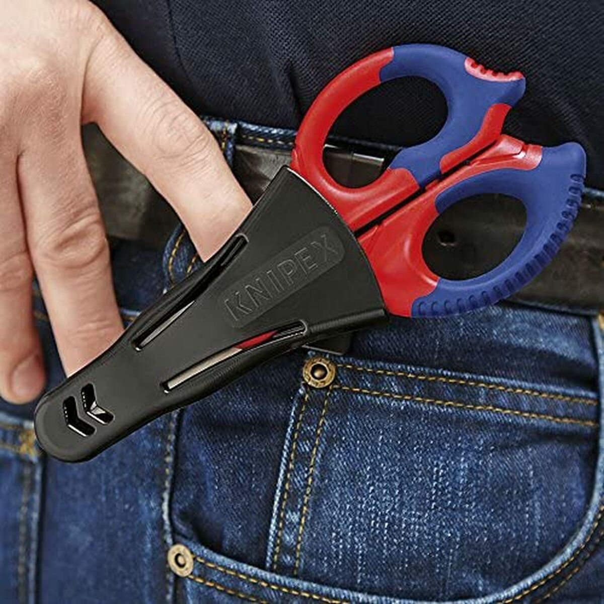 Scissors in a pocket with red and blue handles.