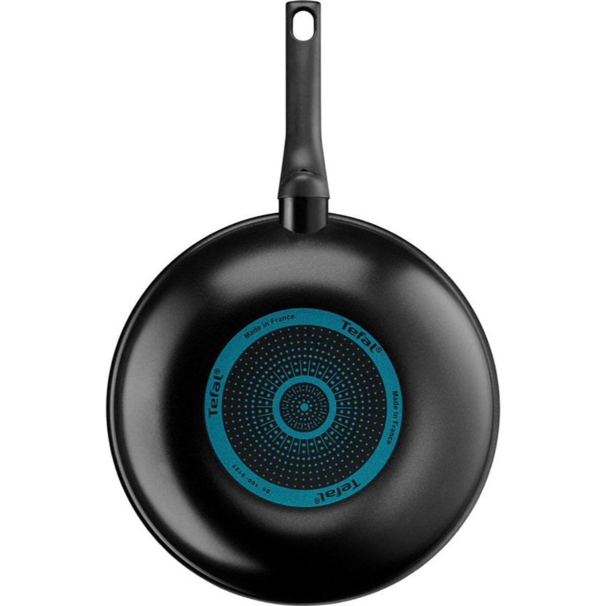Poêle Tefal noire, vue de dessus, avec un motif circulaire bleu sur le fond.