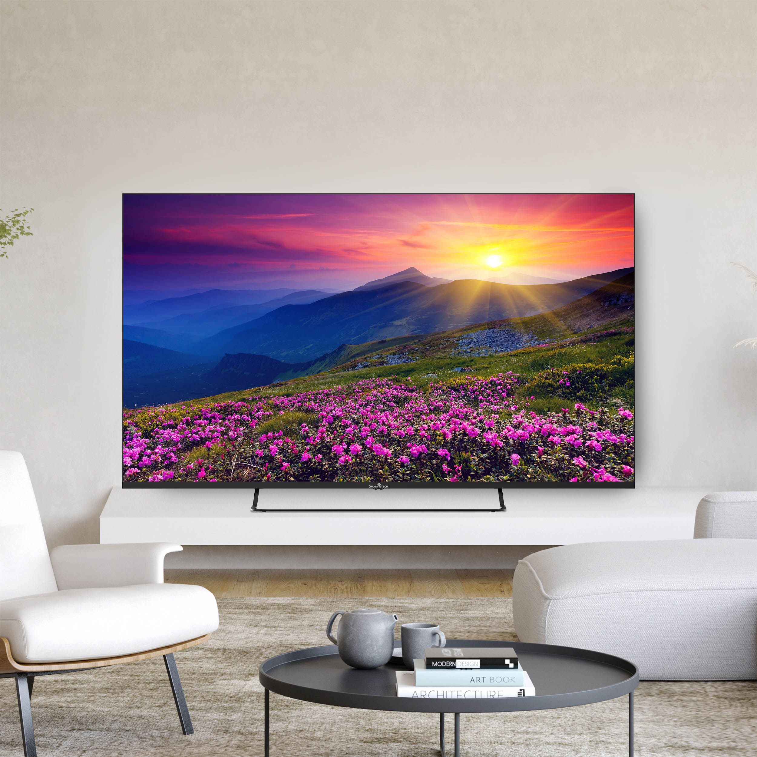Schermo TV mostra tramonto su montagne e campi di fiori viola.
