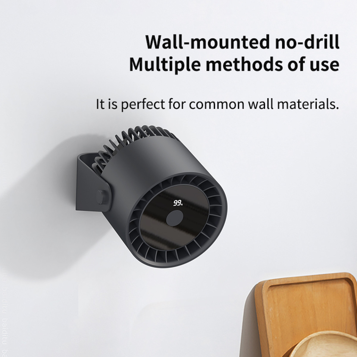 A black wall-mounted fan with a digital display, mounted on a white wall, with wooden trays.