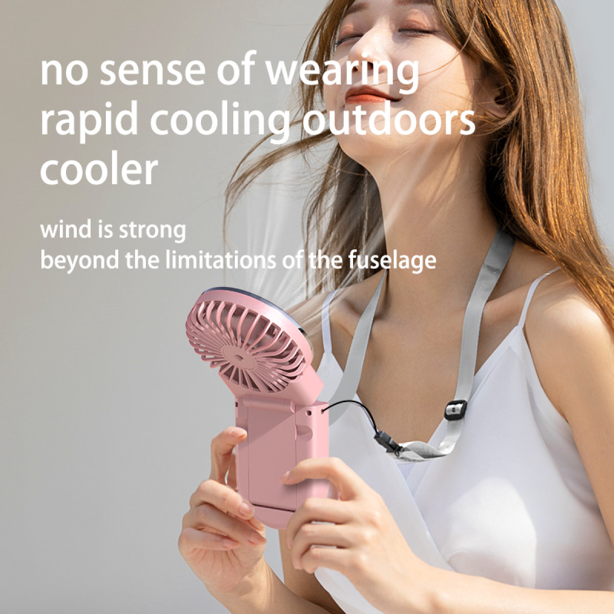 A woman using a pink neck fan outdoors, with text about cooling and wind.