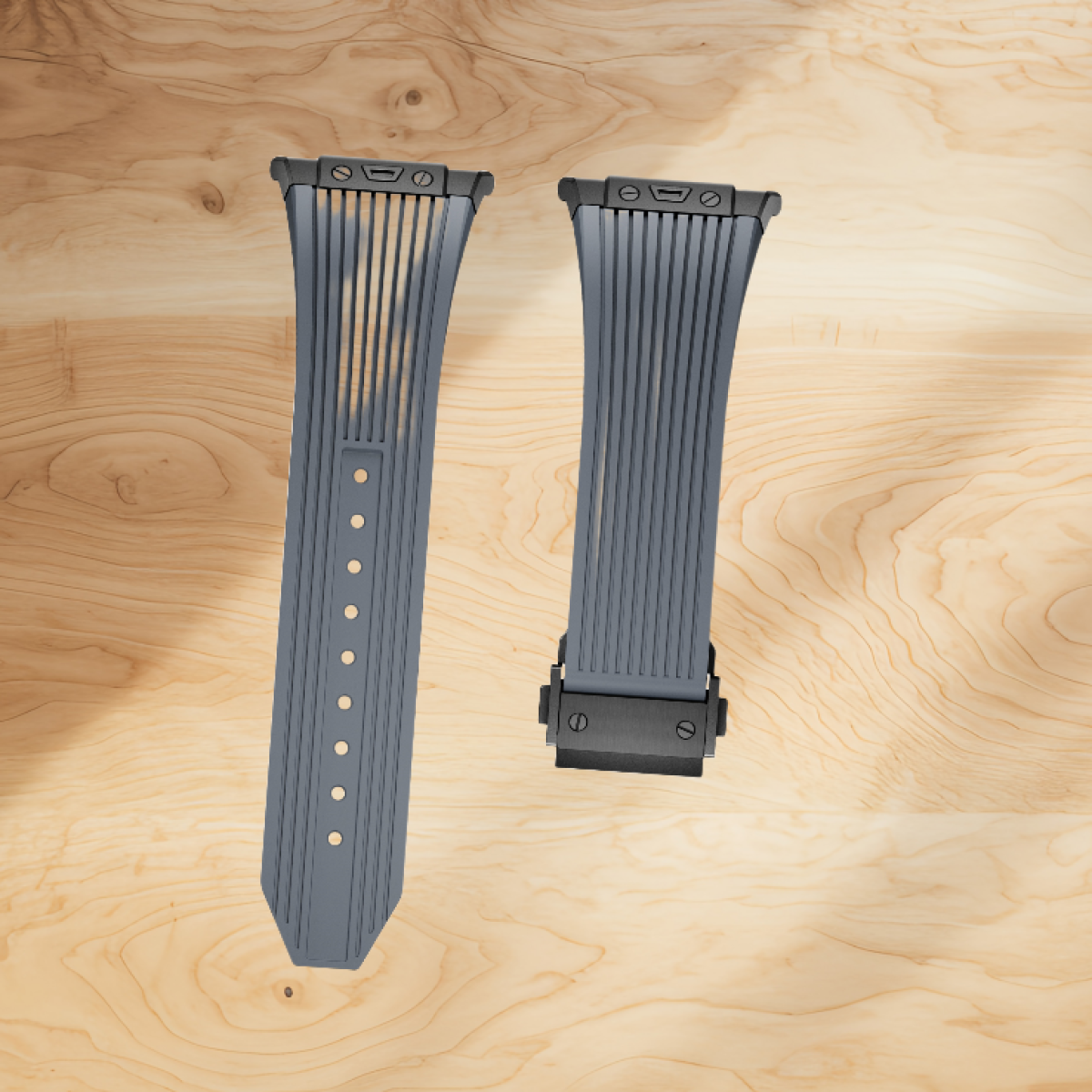 Due cinturini grigi, ciascuno con linee verticali, su una superficie di legno. Ferramenta nera.