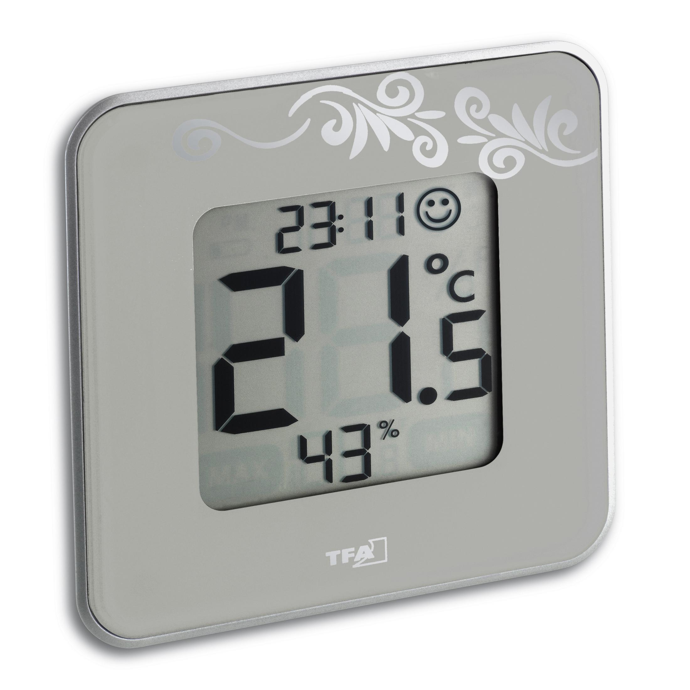 Ein digitales Display zeigt Zeit, Temperatur und Luftfeuchtigkeit, das Design ist grau, mit floraler Kunst.