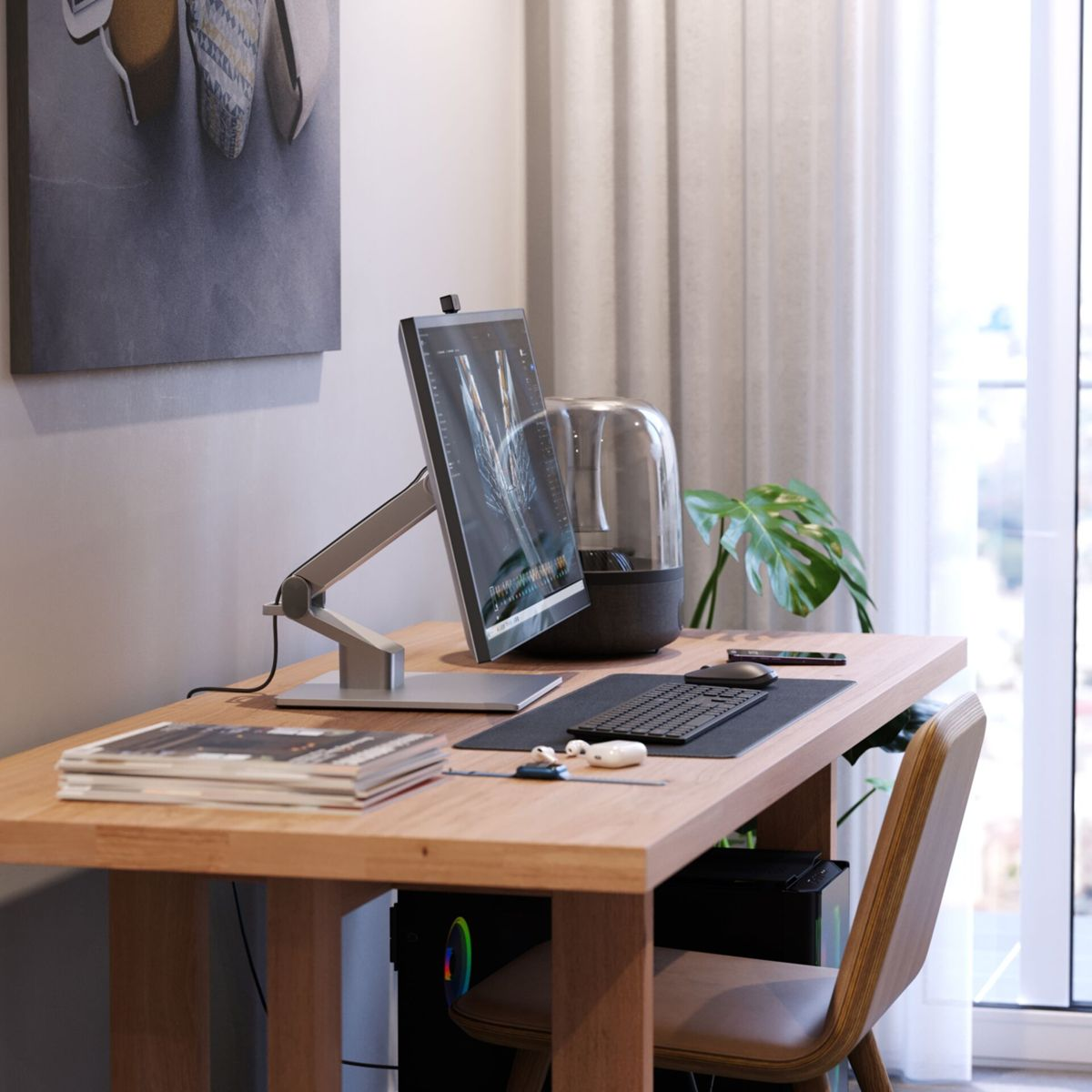 Bureau avec ordinateur et accessoires. Un tableau et une fenêtre en arrière-plan.