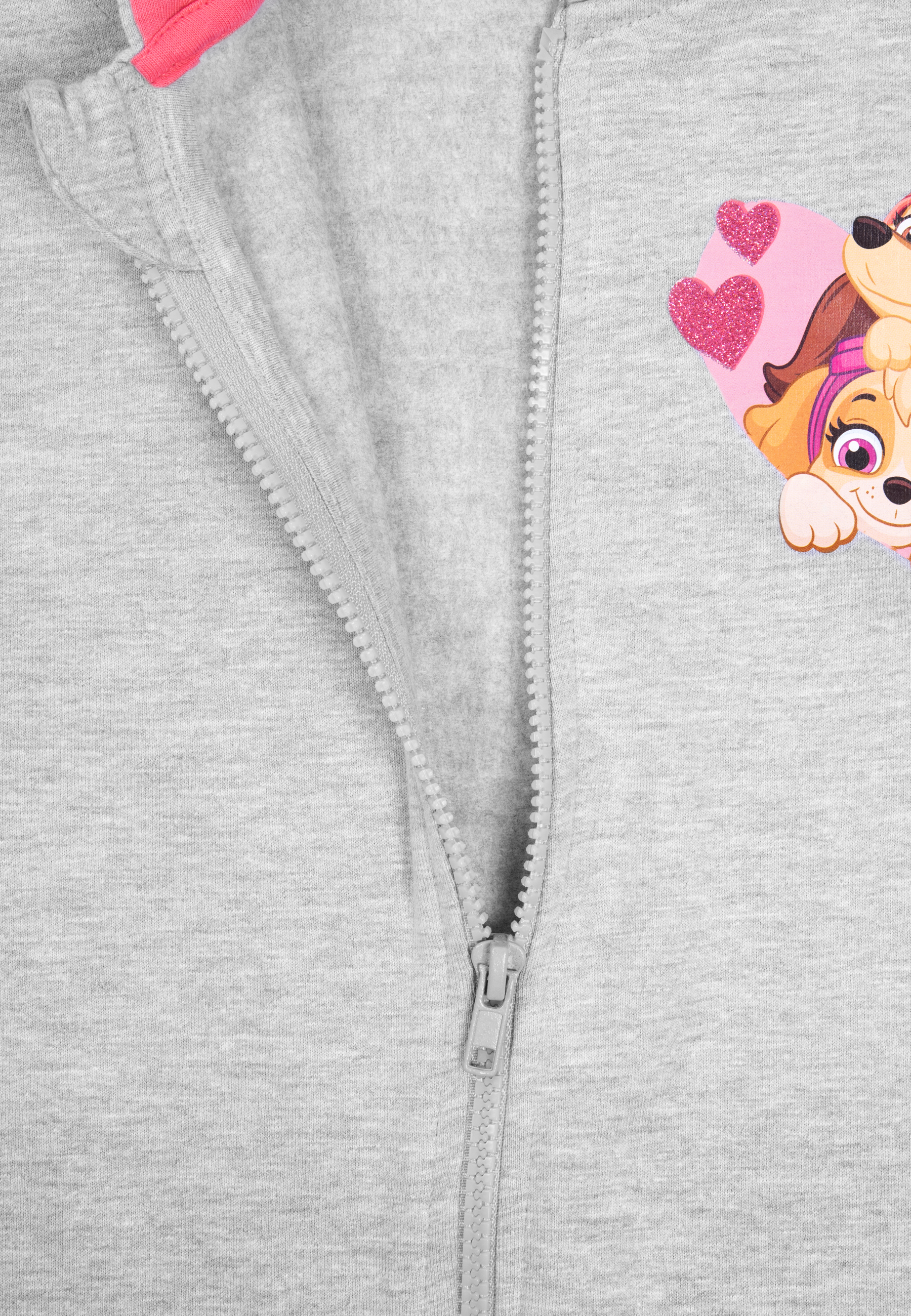 Grauer Overall mit Paw Patrol Herzdesign auf der Vorderseite. Reißverschlussdetail auf der linken Seite.