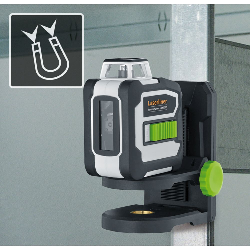 Niveau laser avec support magnétique sur une surface métallique. Couleurs noir, blanc et vert.