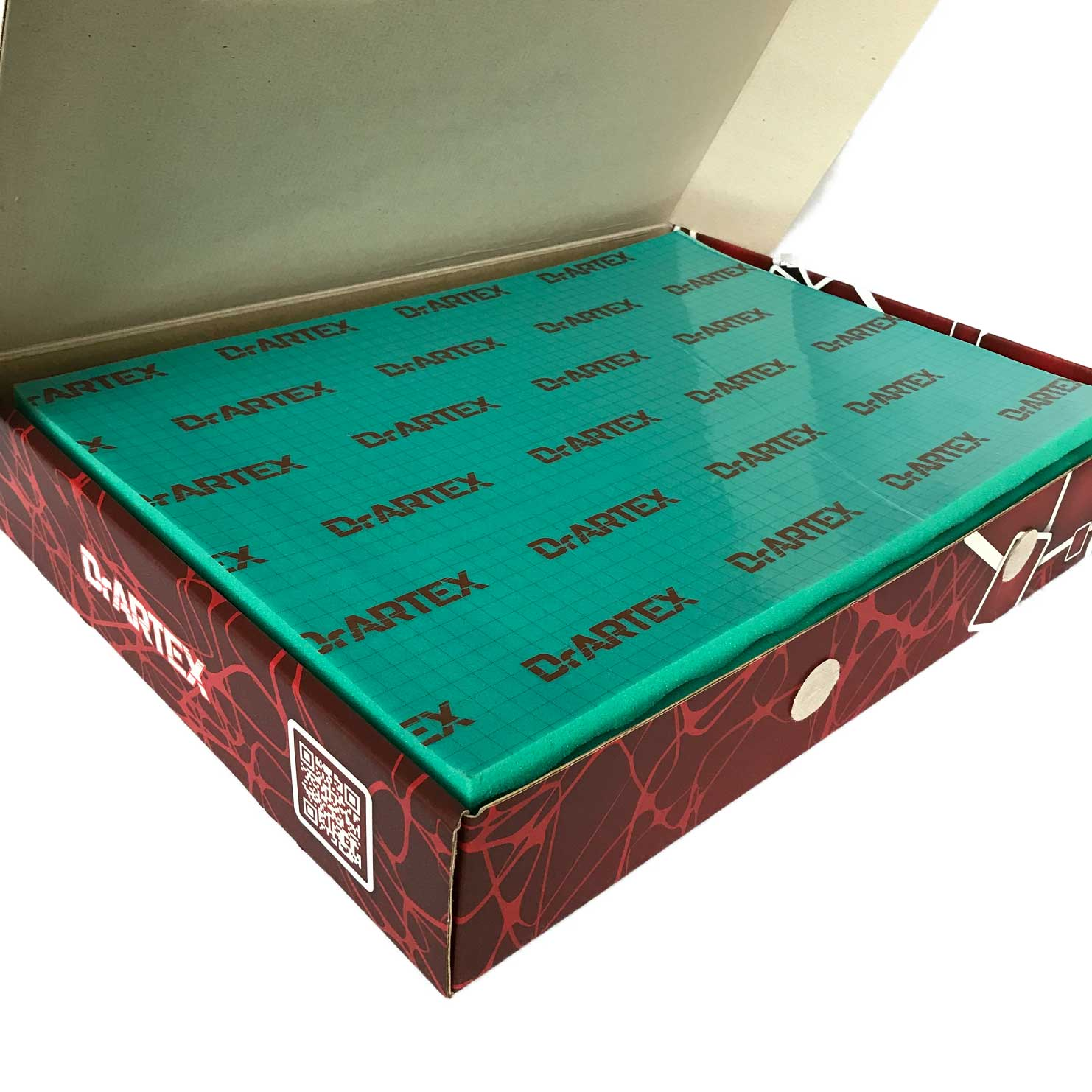 Geöffnete Box mit grünem Brett und dem Text Dr.ARTEX sowie einem Aufkleber mit QR-Code.