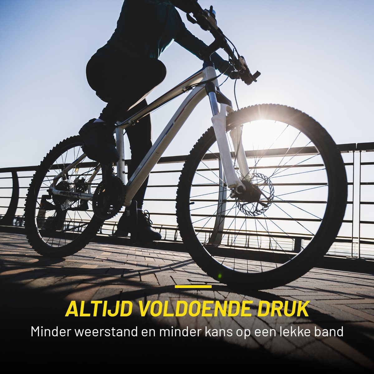Cyclist riding a bike on a paved path. Text reads: Always Sufficient Pressure.