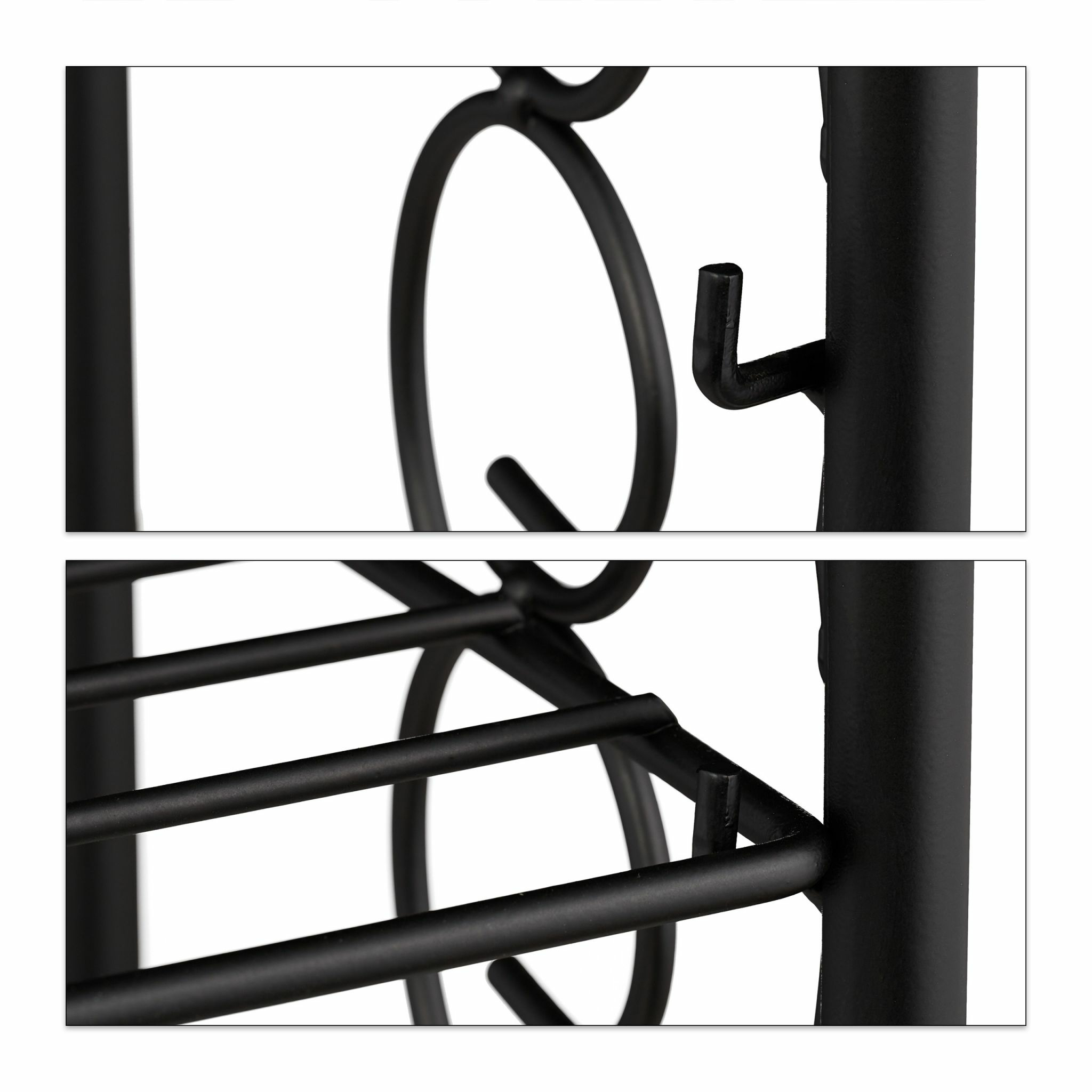 Nahaufnahme von Details des schwarzen Metallgitters: Haken, horizontale Stangen und dekorative Wirbel. Weißer Hintergrund.