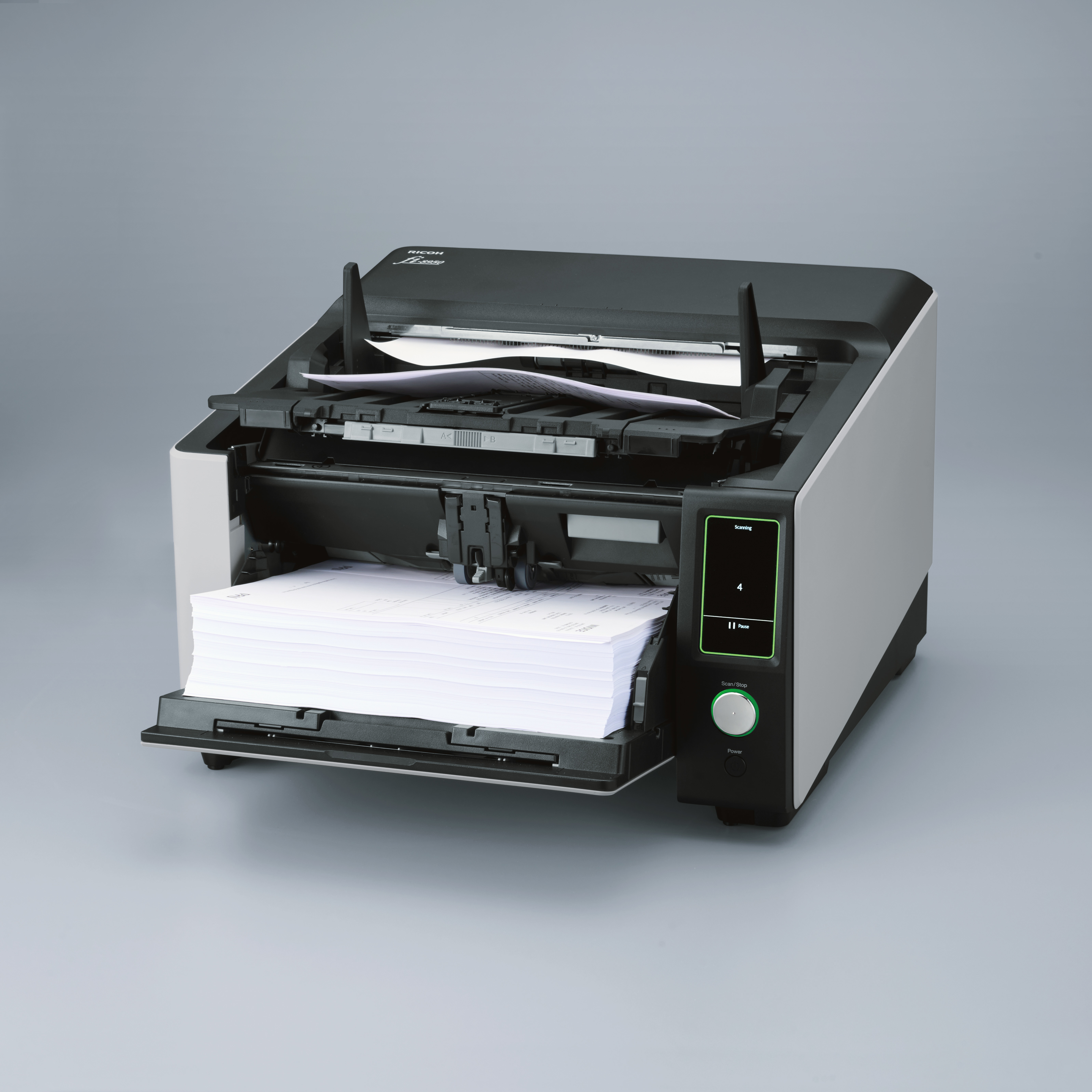 Zwarte en grijze scanner met een stapel papier in de uitvoerlade en een open invoerlade.