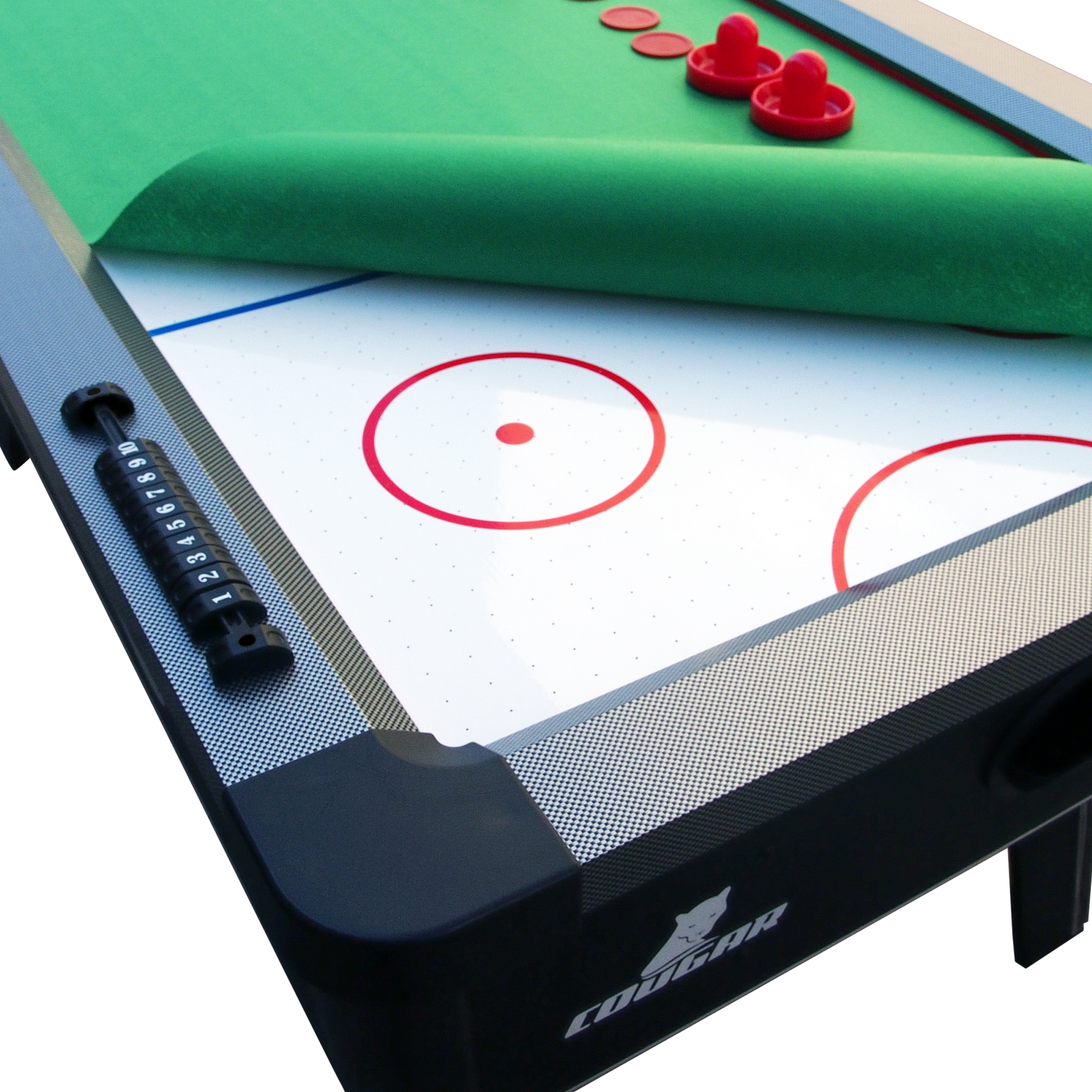 Ein Airhockey-Tisch mit grüner Filzoberfläche, roten Pucks und einem Punktezähler. Schwarz-weißes Design.