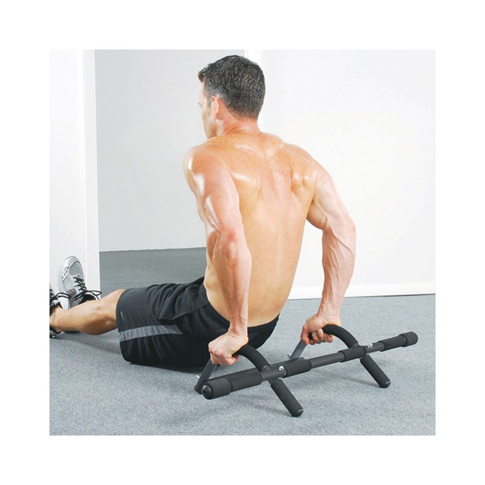 Man doing dips on a dip bar, viewed from the back.