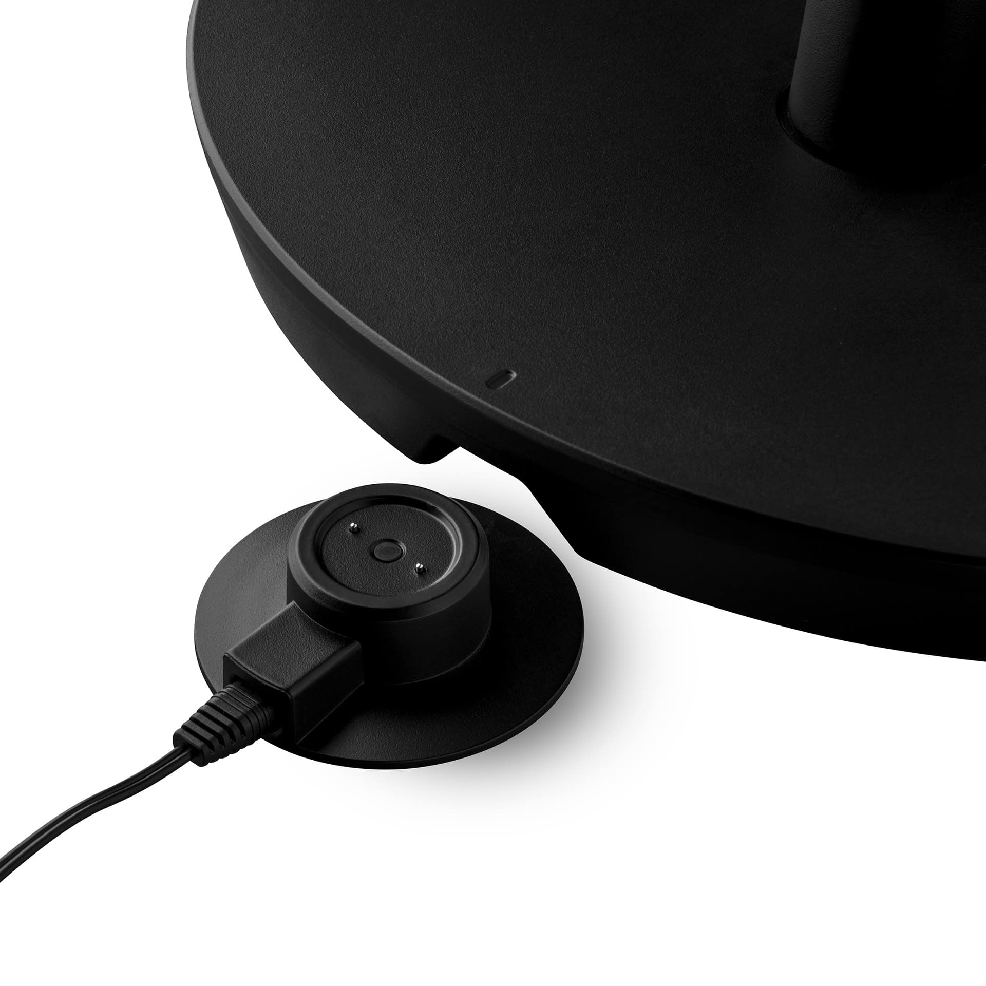 Black charging base with attached cable and a smaller round charging port.