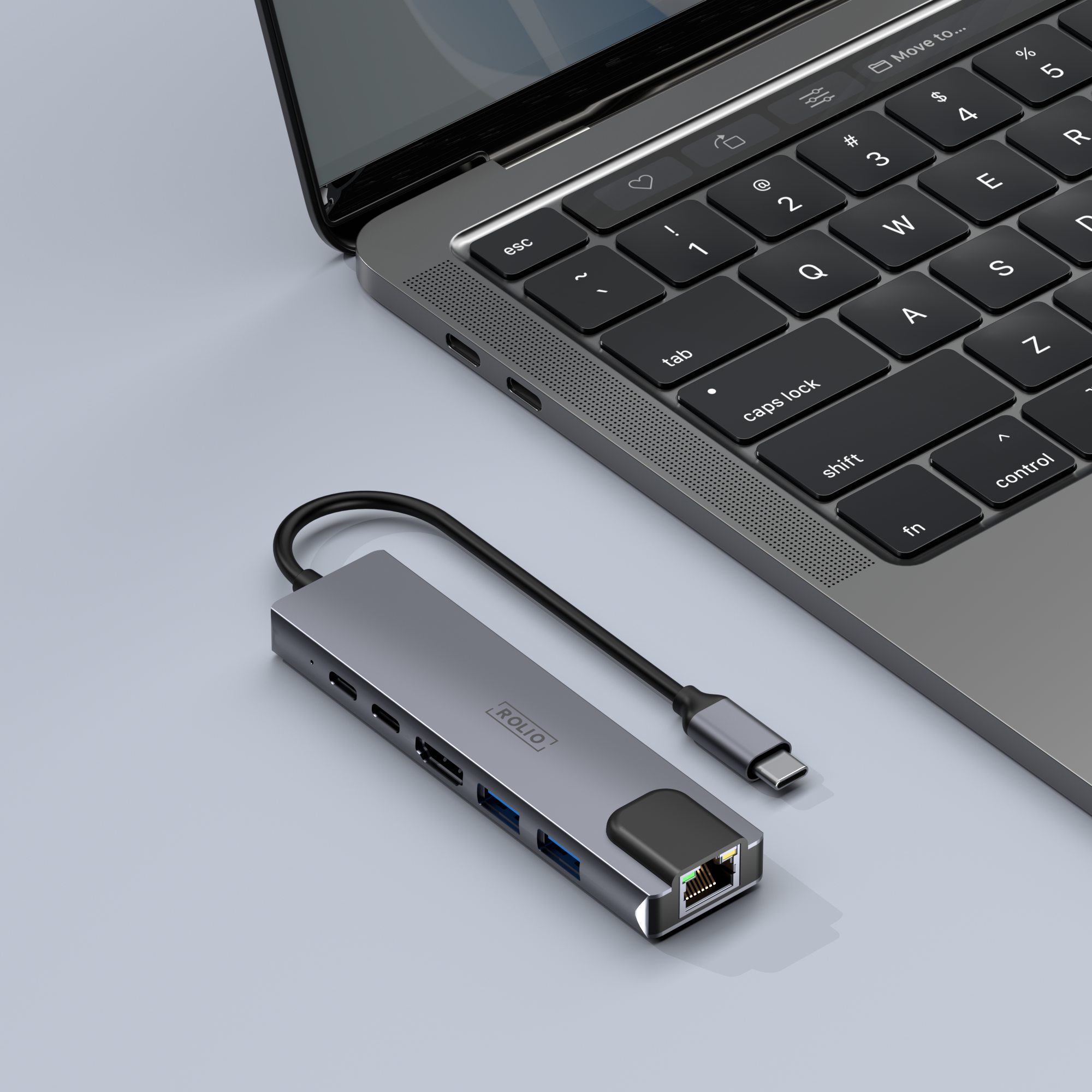 Gray USB-C hub connected to a laptop. The hub has various ports.