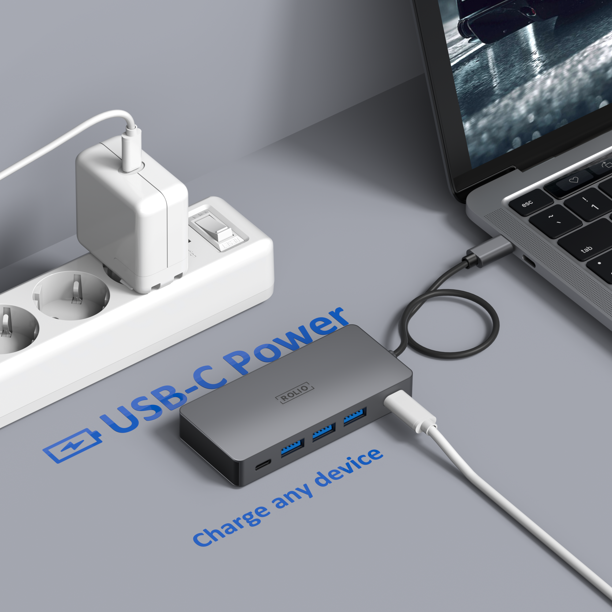 A laptop connected to a USB-C hub with multiple ports. A charging adapter is connected to the hub.