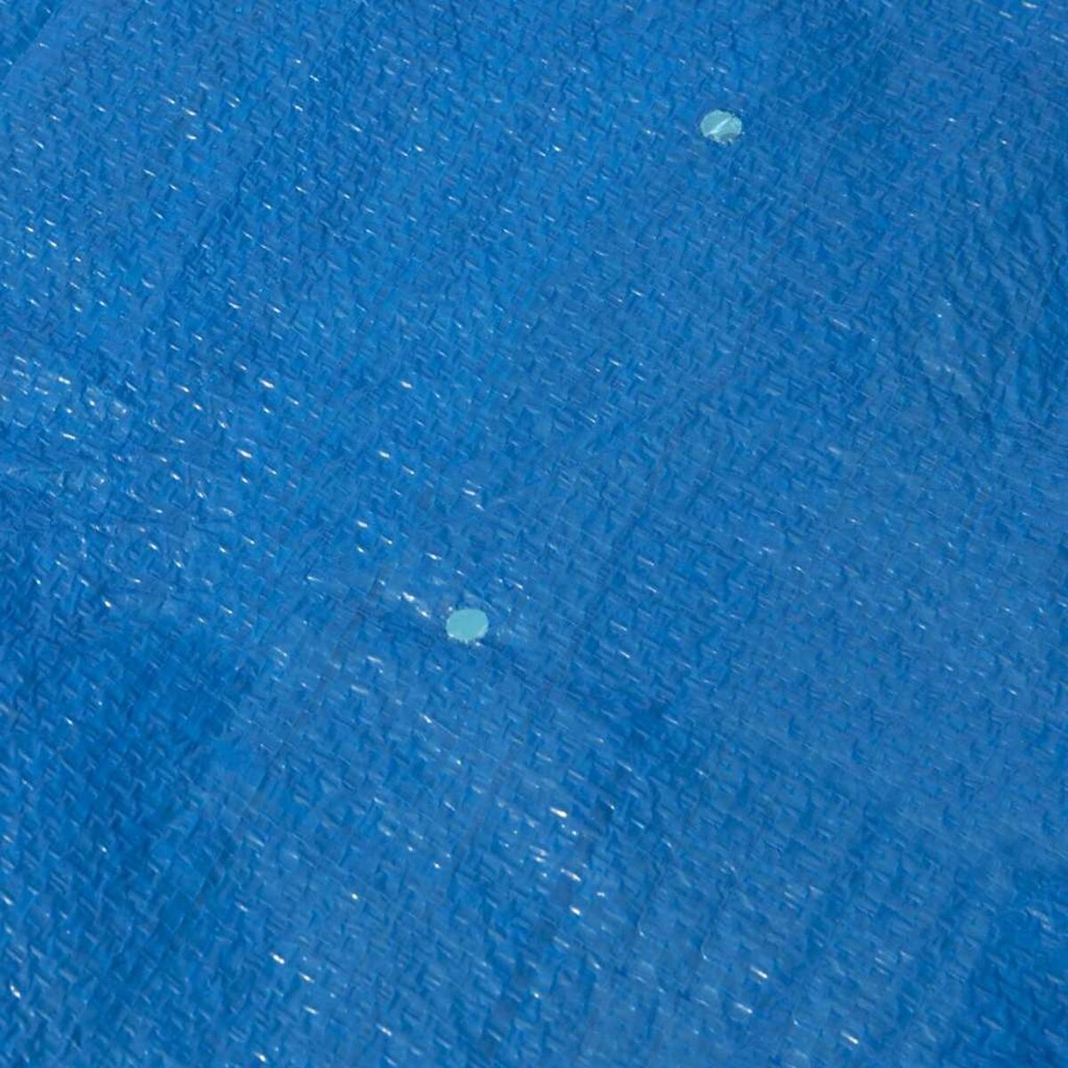 Nahaufnahme einer blauen Plane mit zwei hellblauen Kreisen darauf.