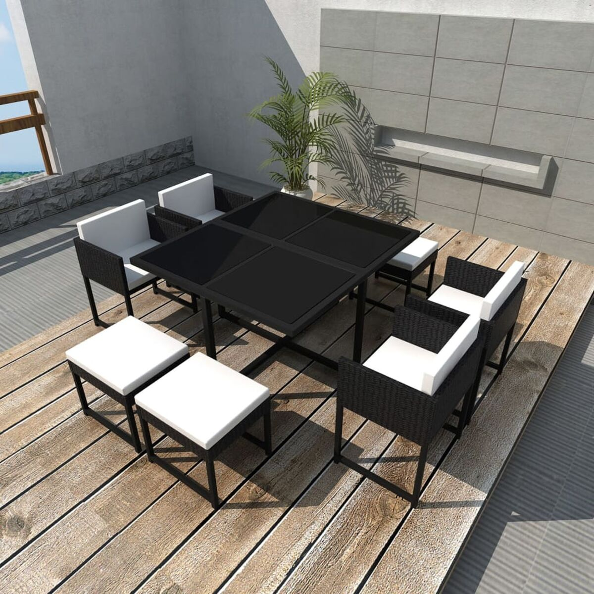 Terrassenmöbel mit schwarzem Tisch, Stühlen und weißen Kissen.