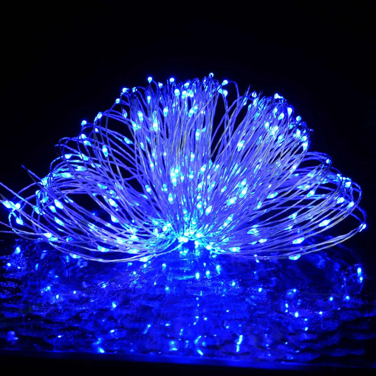 Blaue LED-Lichterkette, beleuchtet auf schwarzem Untergrund.