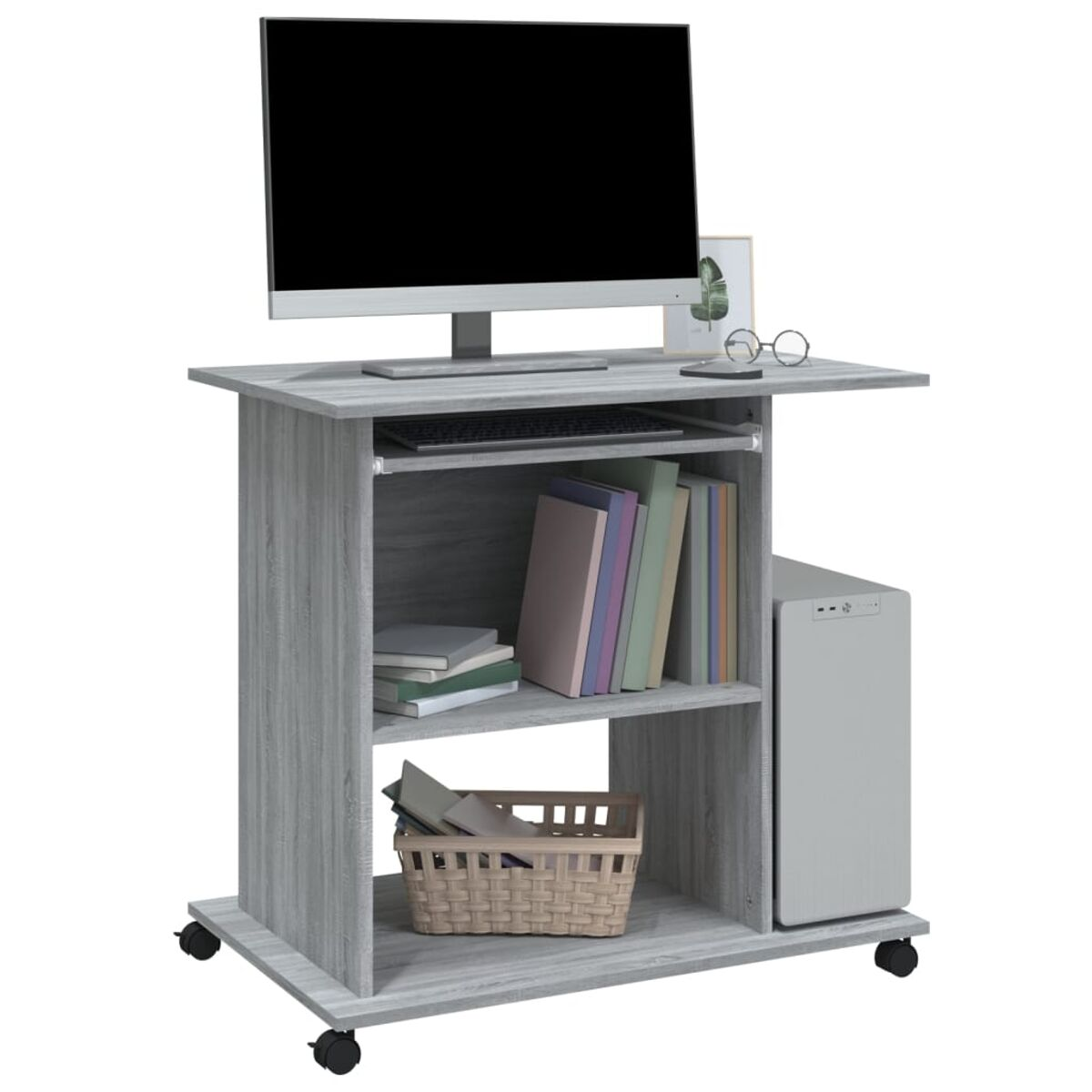 Grauer Computertisch mit Computer, Tastatur, Büchern, Korb und einem Computer-Tower auf Rädern.