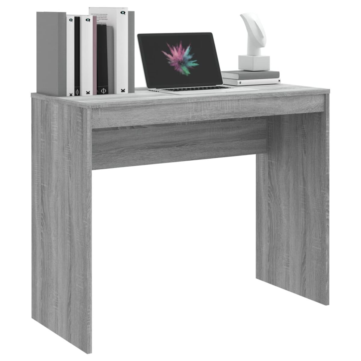 Grauer Schreibtisch mit Büchern, Laptop und Skulptur.