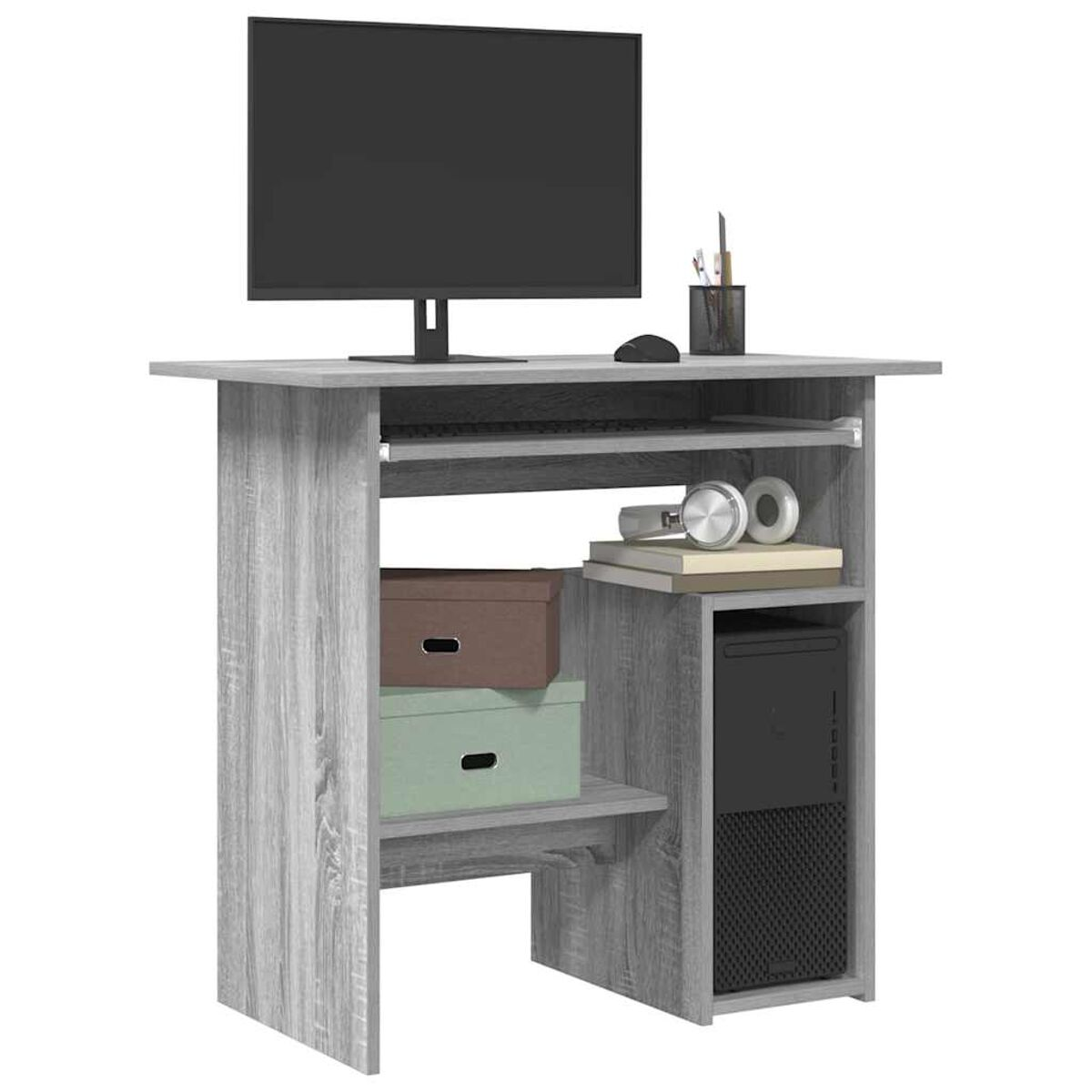 Ein grauer Computertisch mit Monitor, Tastatur und Computer-Tower. Boxen und Bücher stehen auf den Regalen.