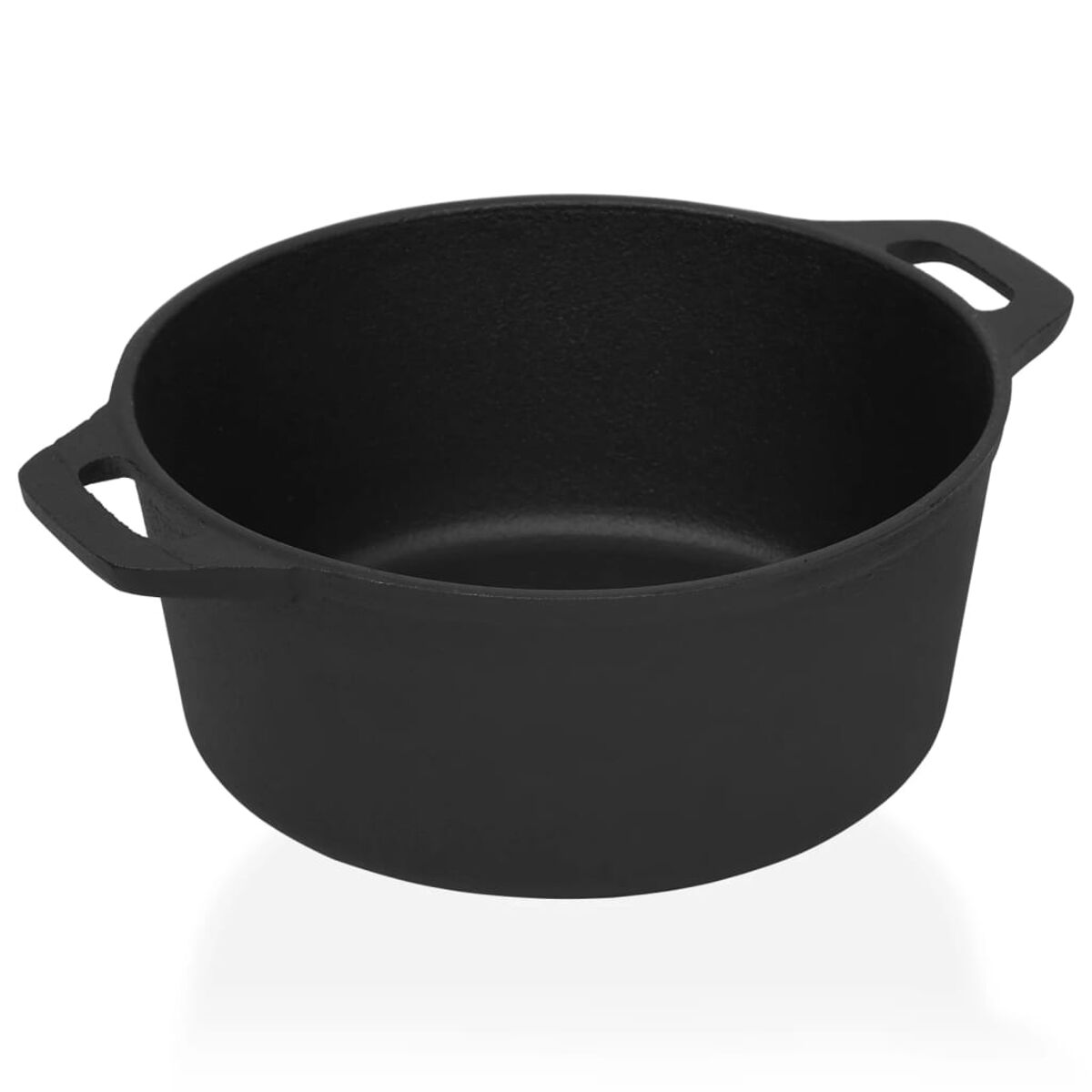Olla negra de hierro fundido con dos asas sobre superficie blanca.