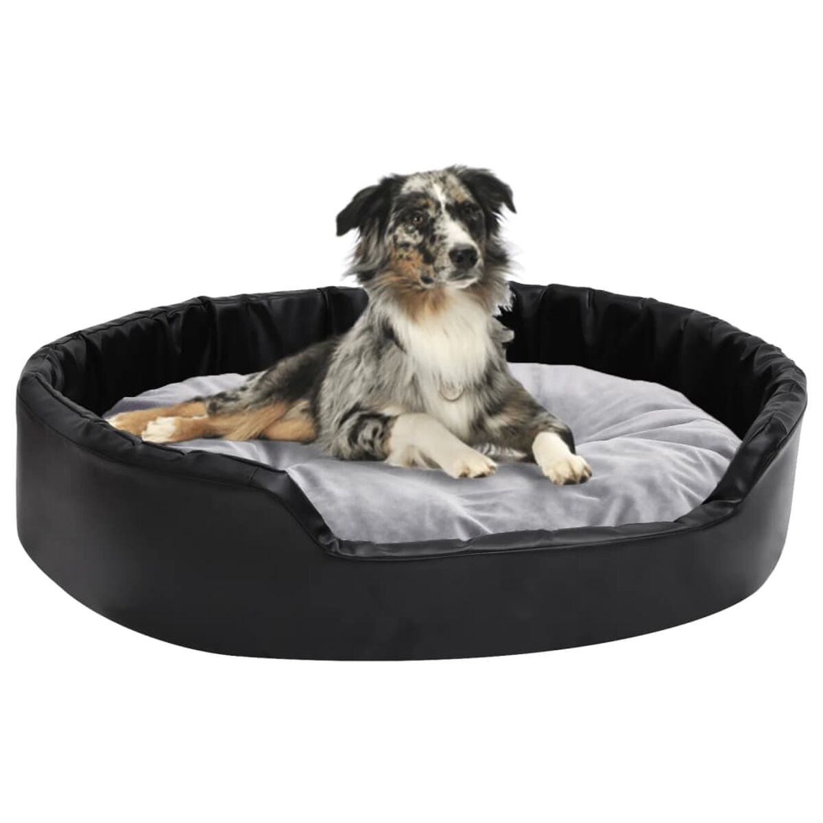 Hundebett mit schwarzer Außenseite, hellgrauem Kissen und einem Hund darin.