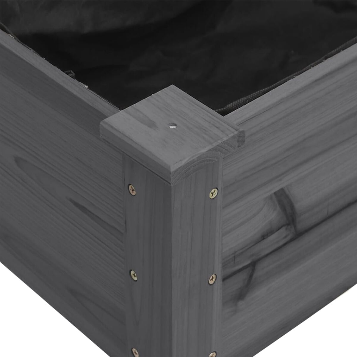 Nahaufnahme einer Ecke eines grauen Holzpflanzgefäßes. Die Ecke ist mit Schrauben verbunden.