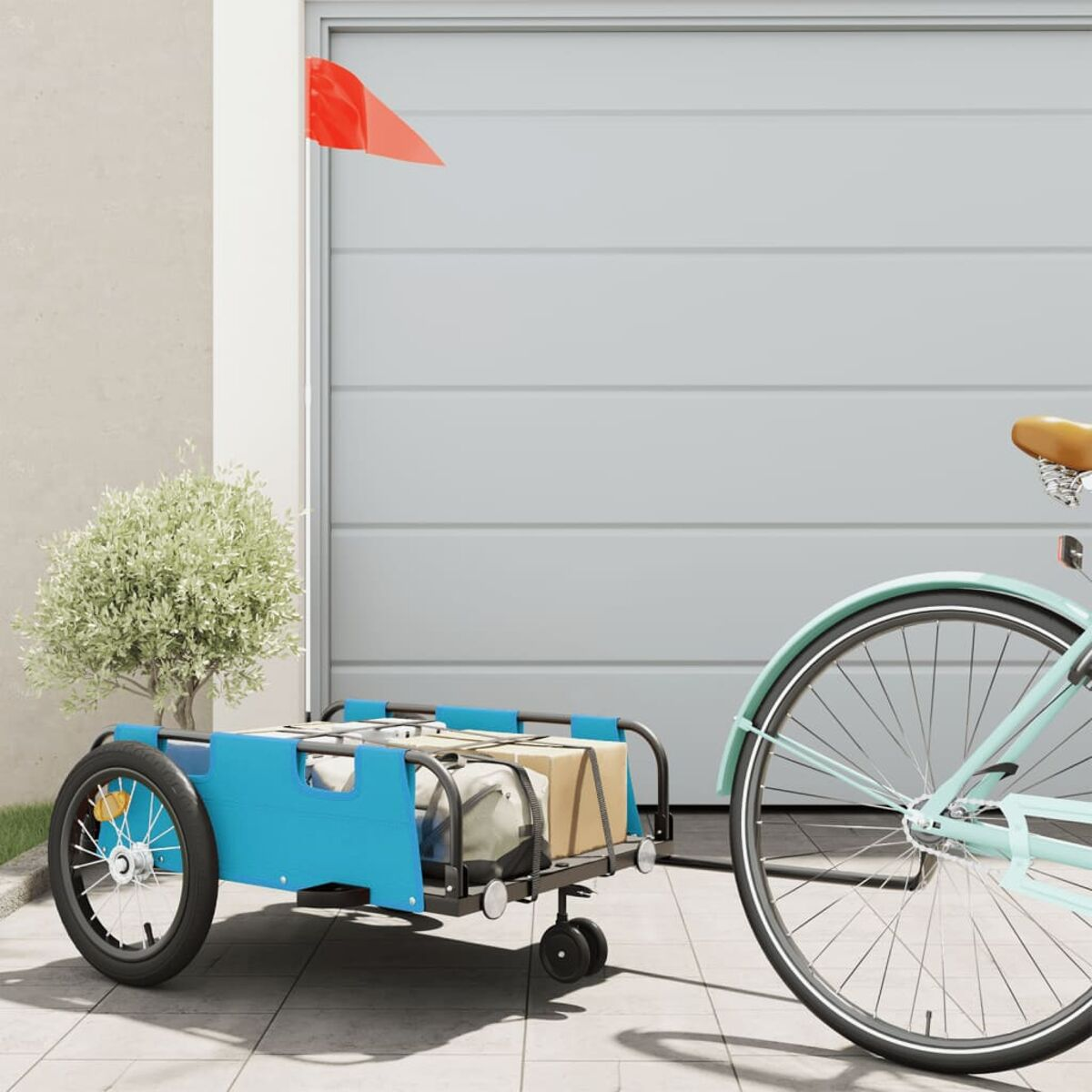 Blauer Fahrradanhänger mit Flagge, Kartons und Fahrrad. Garagenhintergrund.