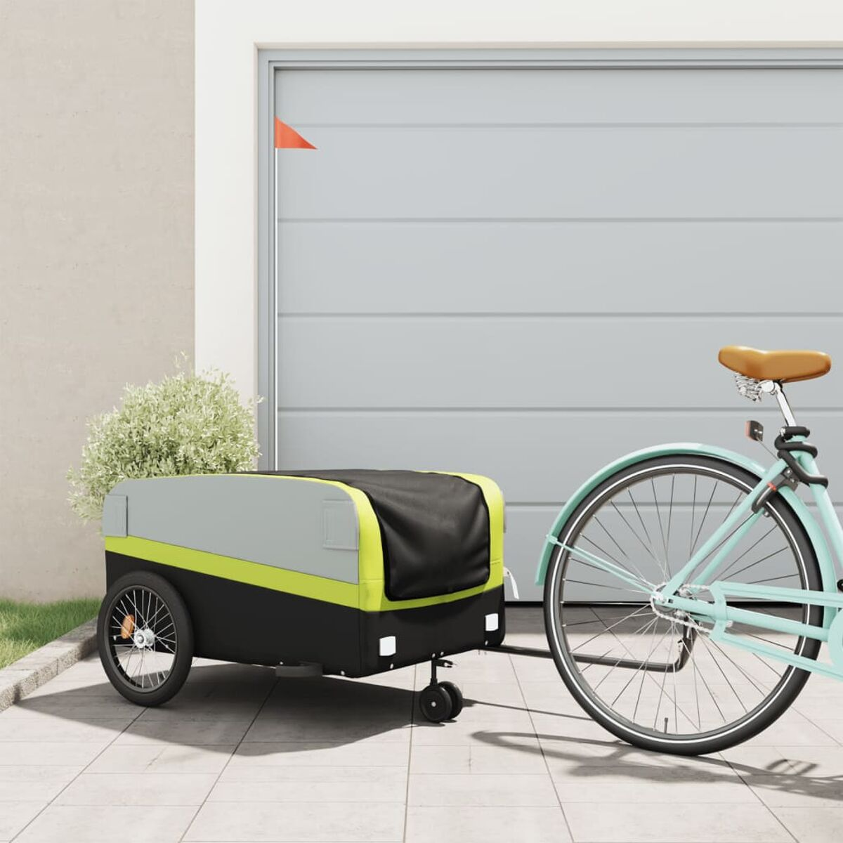 Ein Fahrrad mit Anhänger. Der Anhänger ist grau und schwarz. Eine grüne Linie oben.