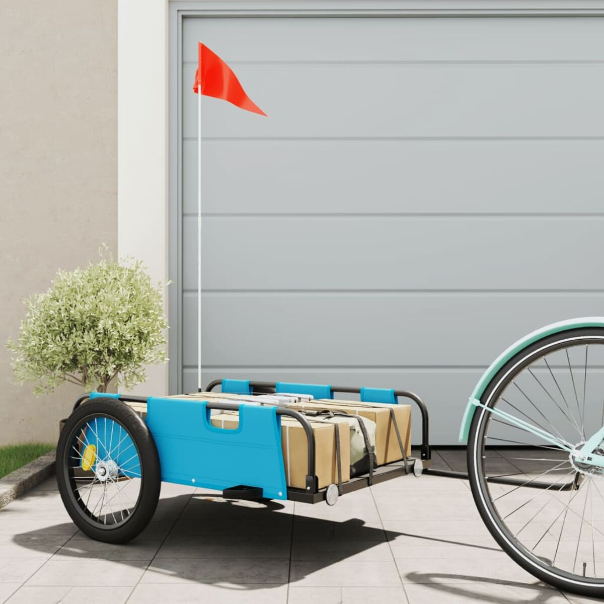 Fahrradanhänger am Fahrrad. Blauer Anhänger mit Kisten. Rote Fahne und Garage.