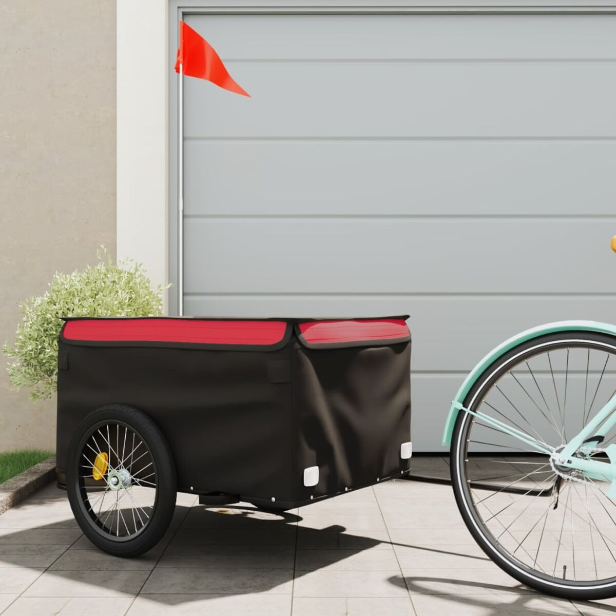 Schwarzer und roter Fahrradanhänger mit Fahrrad. Garagenhintergrund.
