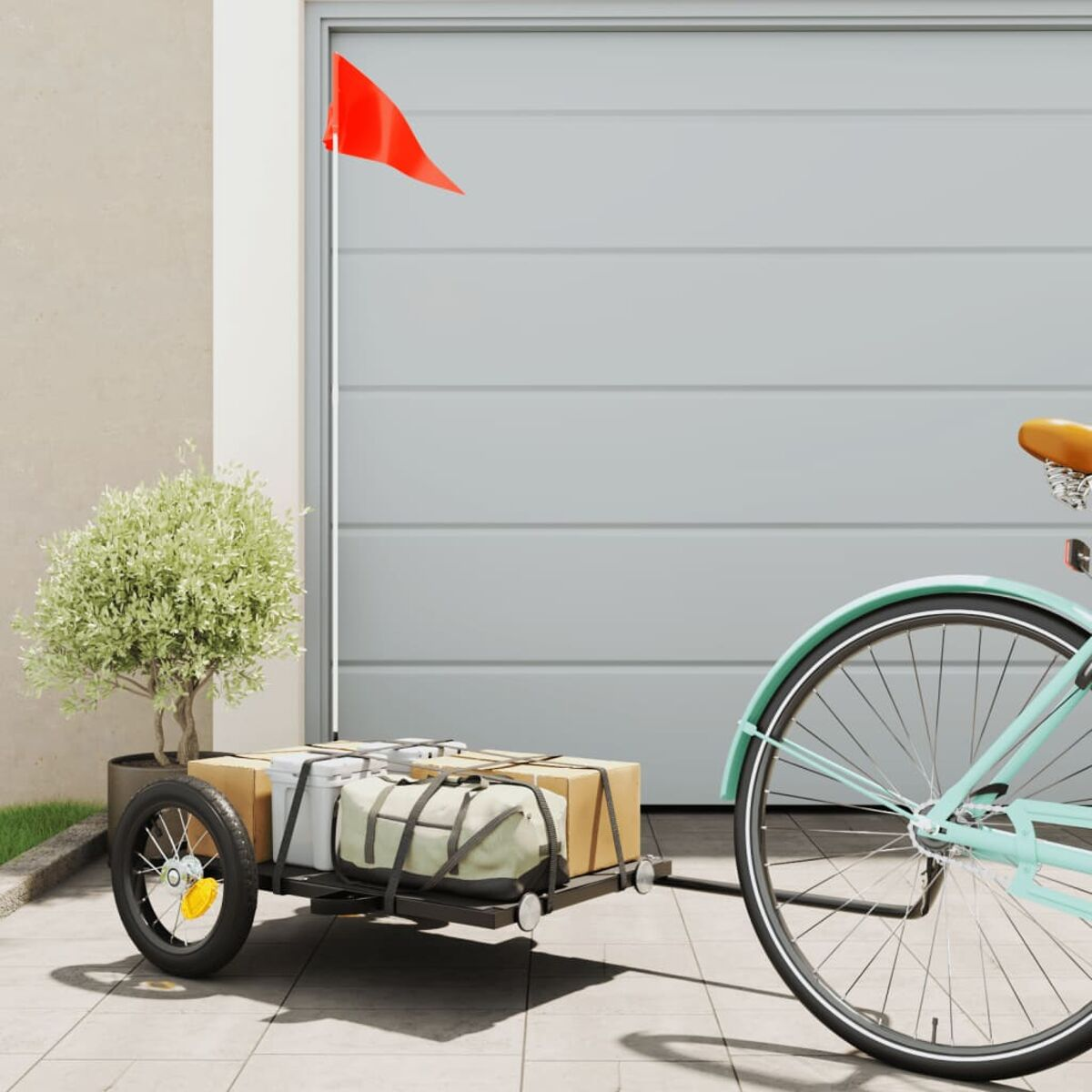 Ein Fahrrad mit Anhänger. Der Anhänger transportiert Kartons und Taschen.