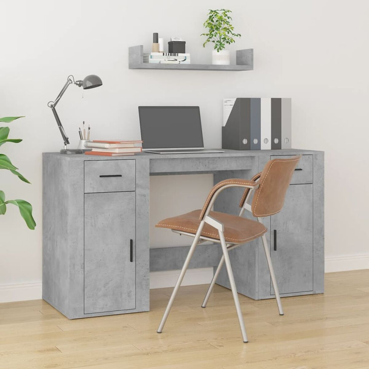 Ein Schreibtisch mit Computer, Büchern und Büromaterial. Es gibt einen Stuhl und ein Regal darüber.