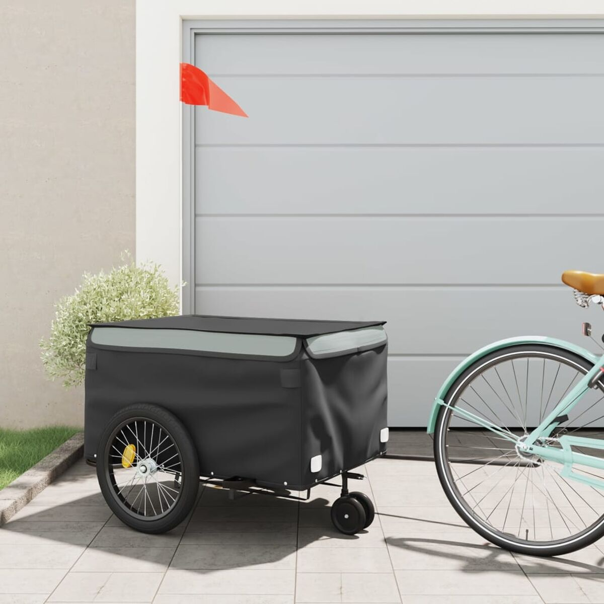 Schwarzer Fahrradanhänger mit roter Flagge und Fahrrad.