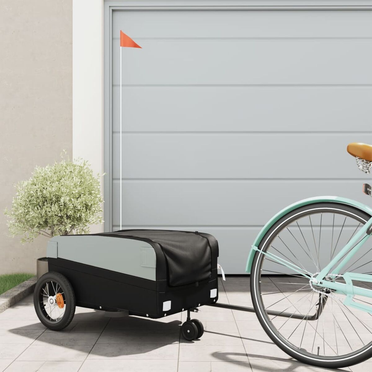 Ein Fahrrad zieht einen grau-schwarzen Anhänger mit schwarzem Dach.