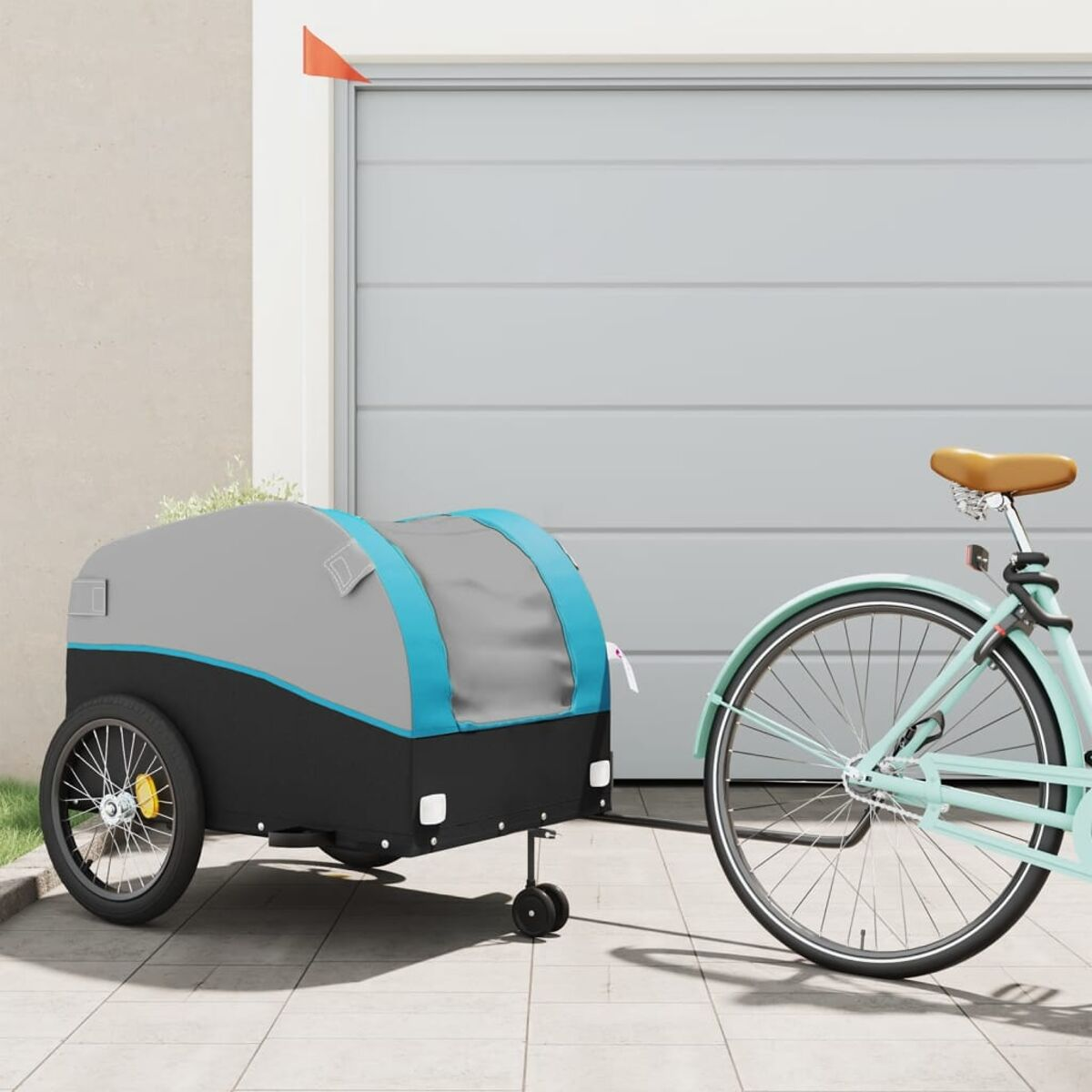 Ein Fahrrad zieht einen Fahrradanhänger. Der Anhänger ist grau und schwarz mit blauer Umrandung.