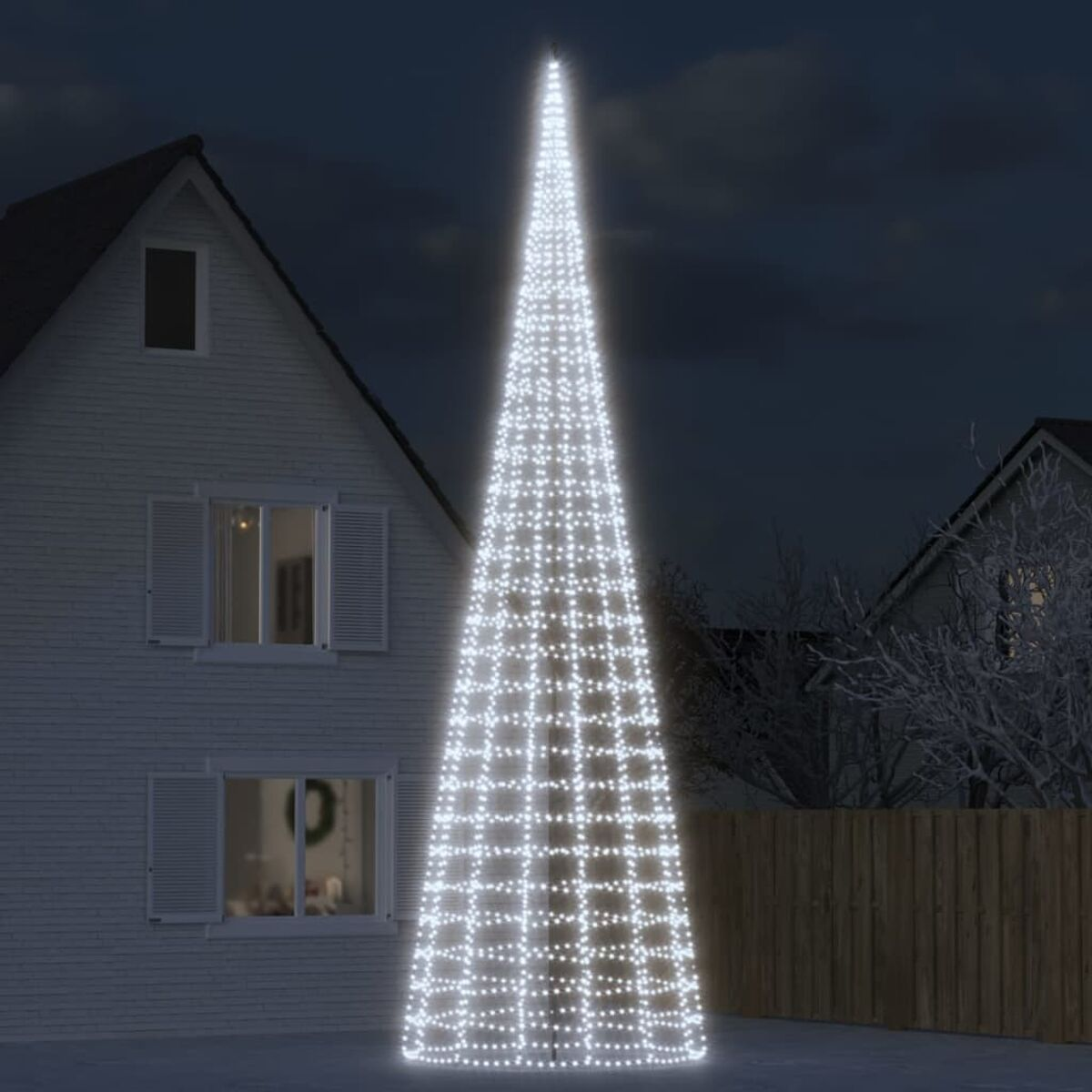 Ein hoher, beleuchteter Weihnachtsbaum aus weißen Lichtern in einem Garten. Im Hintergrund ein Haus.