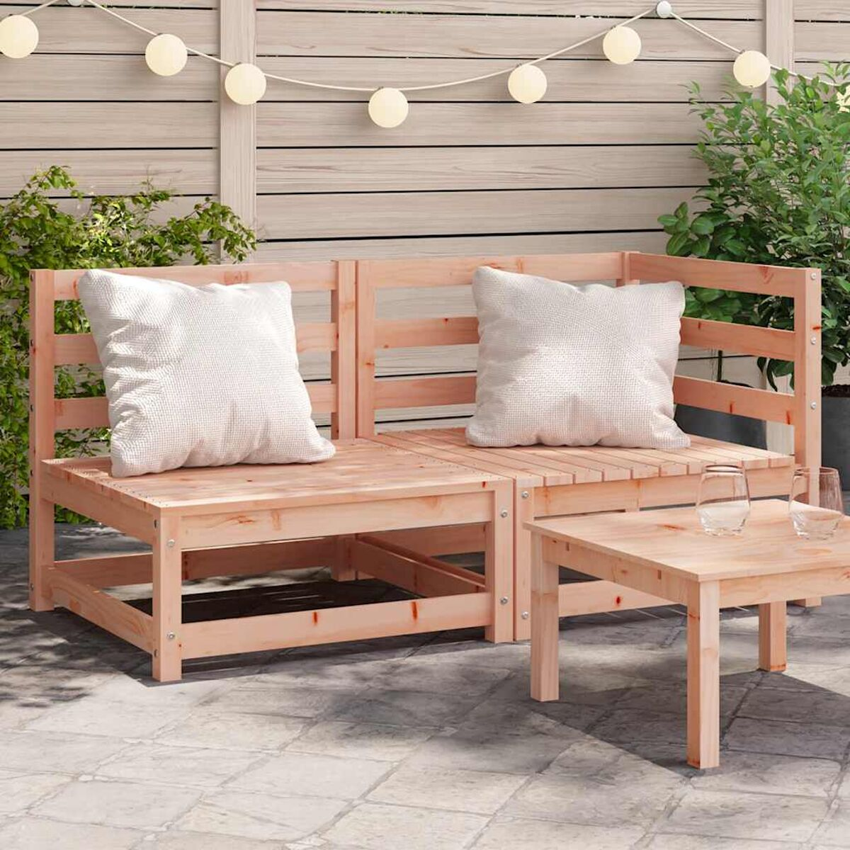 Ein Holzsofa und ein kleiner Tisch. Weiße Kissen und ein weißer Hintergrund mit Lichtern.