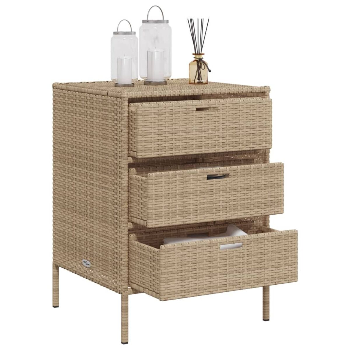 Ein beiger Rattan-Schrank mit drei Schubladen, Glaslaternen und einer Diffusorflasche oben.