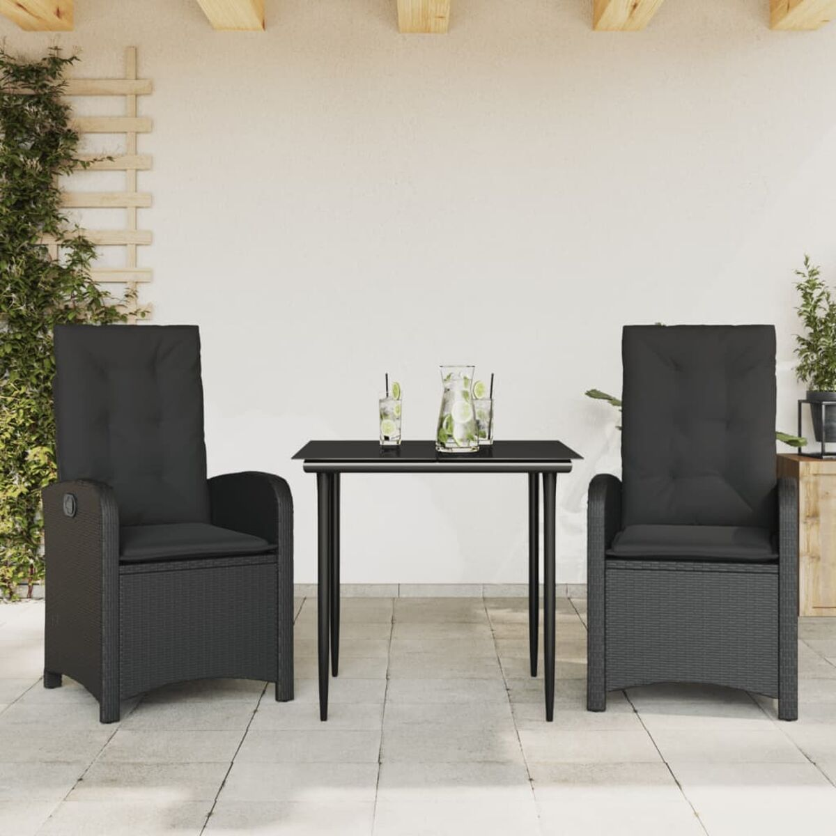 Szene im Freien mit zwei schwarzen Rattan-Stühlen und einem kleinen Tisch mit Getränken.