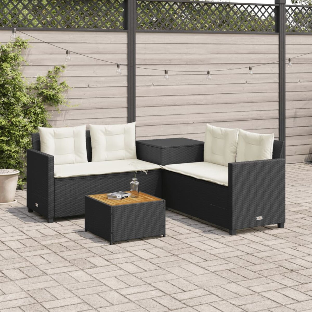 Outdoor-Sofa-Set aus schwarzem Korbgeflecht mit weißen Kissen, einem Tisch mit Holzplatte und gefliestem Boden.